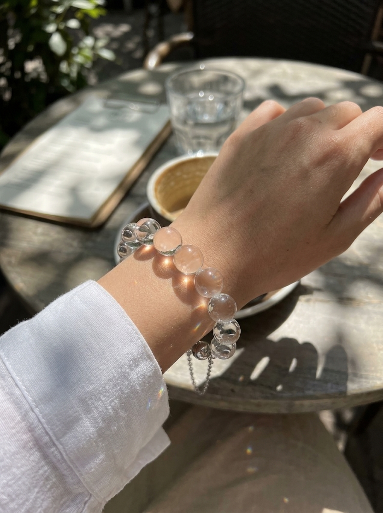 Bubble bracelet sparkling in sunlight at a cafe